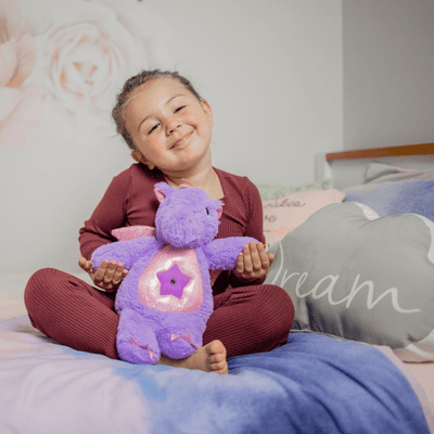 Toddler hugging a purple Glow Buddy
